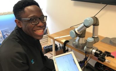 Joshua happily programming UR cobot